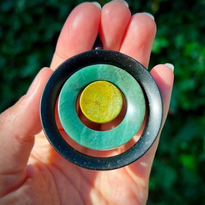 Pounamu greenstone necklace in hand