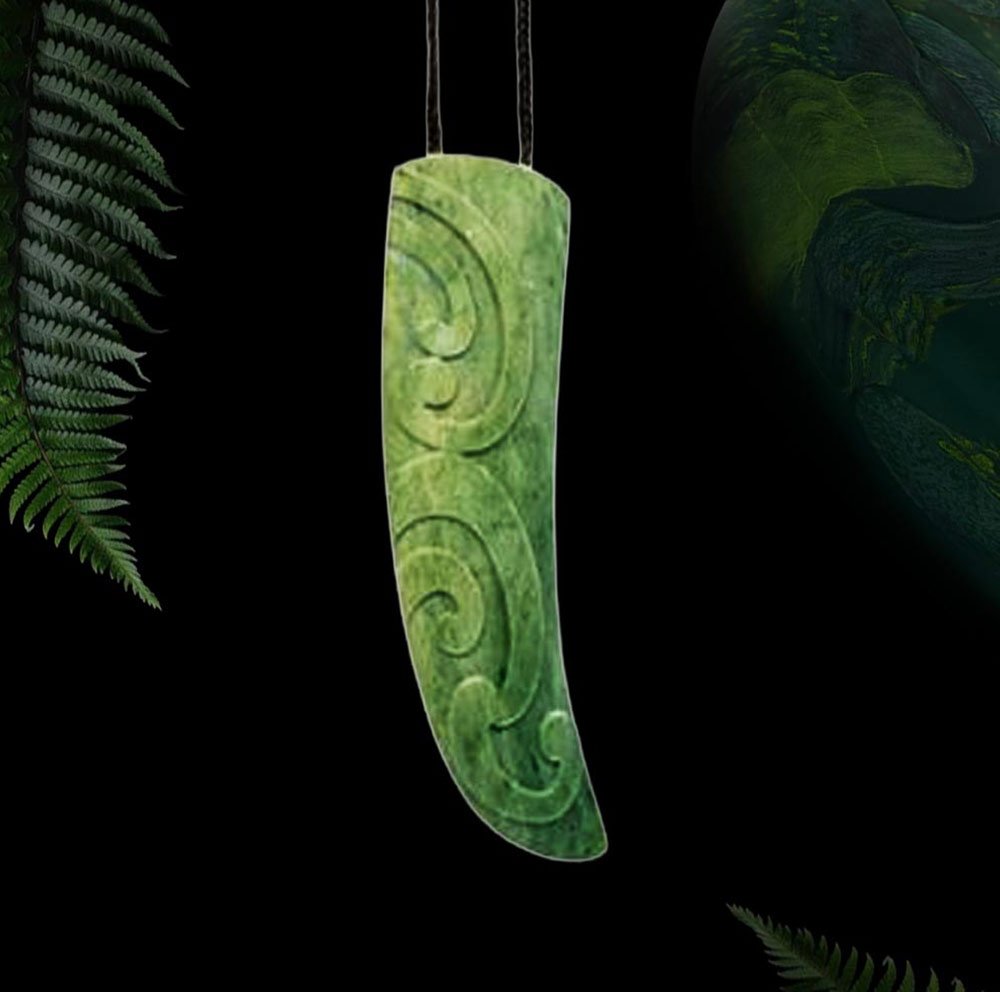 Pounamu rei puta pendant in the curved shape of a sperm whale tooth, carved with koru spirals