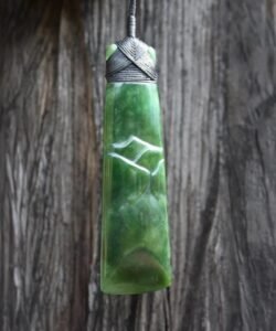 Geoff Williams hand carving New Zealand pounamu greenstone in his Golden Bay studio