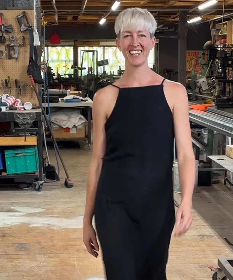Hannah Sheehan smiling in the shared Auckland workshop where she makes her pounamu jewellery