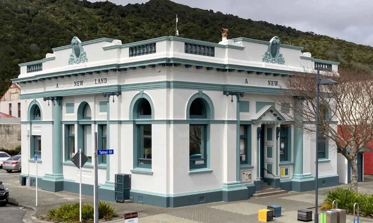 Left Bank Art Gallery in Greymouth, a white and teal former Bank of New Zealand building on Tainui Street