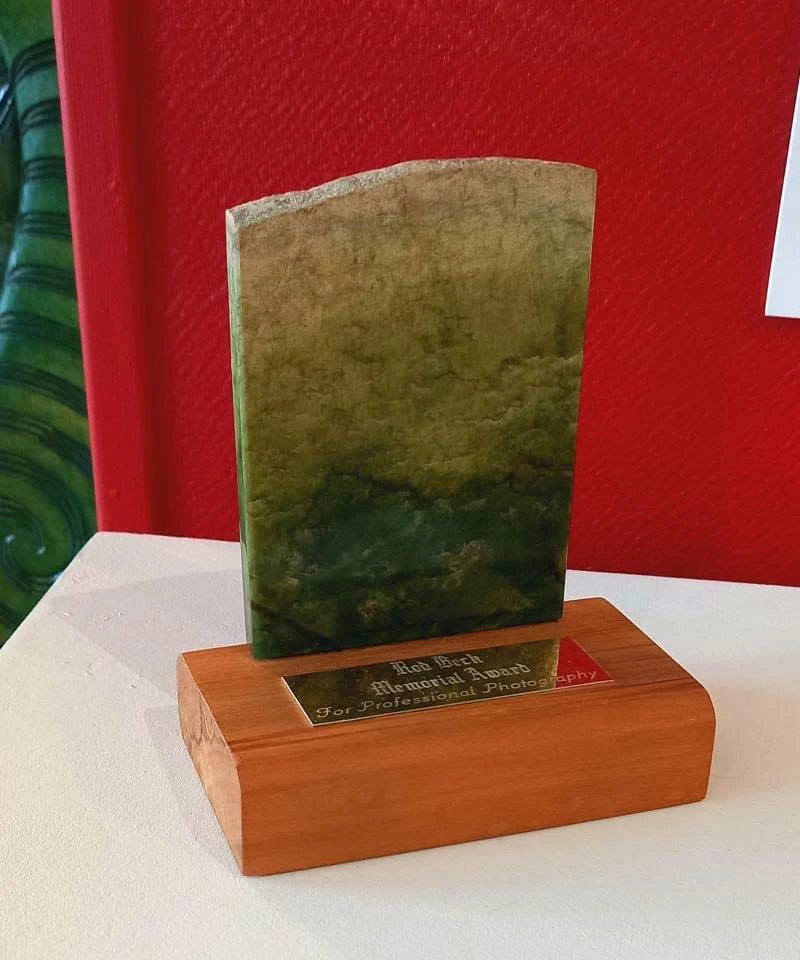 Rod Beck Memorial Award, a polished slab of pounamu on a wooden base, on display at Left Bank Art Gallery
