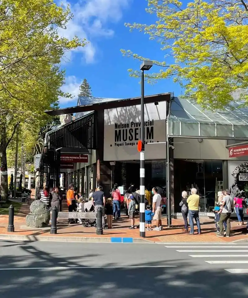 Visitors outside Nelson Provincial Museum on the corner of Hardy Street in central Nelson