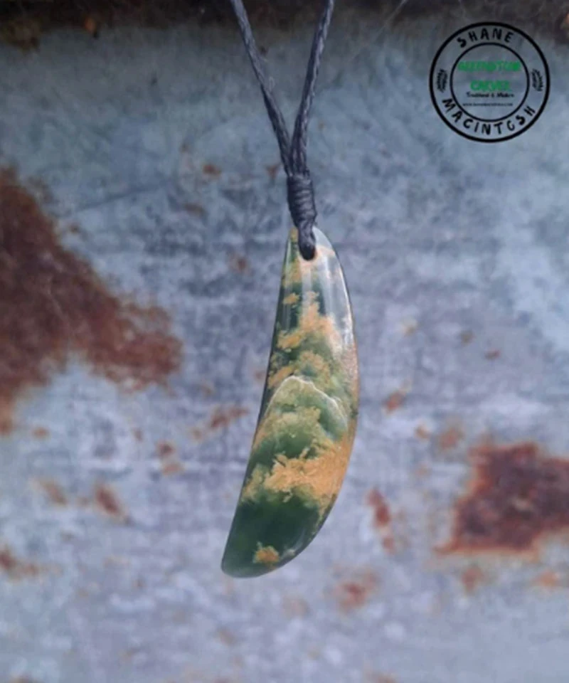 Curved flower jade pounamu pendant with golden markings on a black cord, carved by Shane MacIntosh