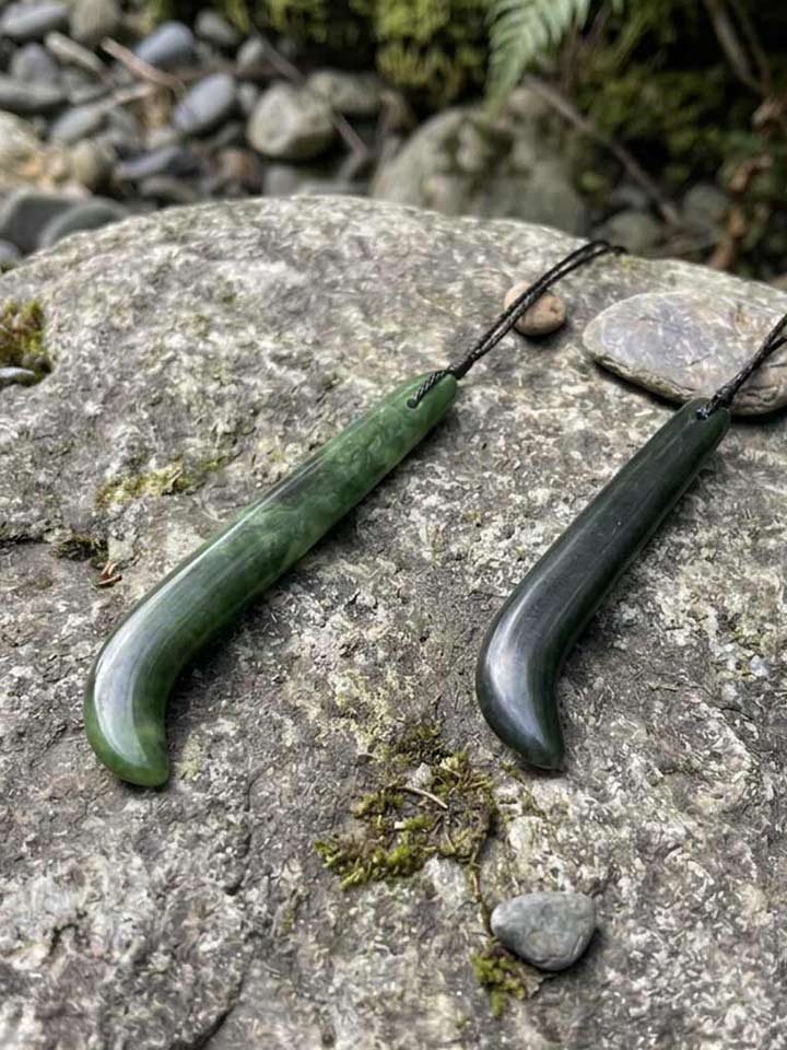 Two kapeu pounamu greenstone necklaces, curved hook-form pendants